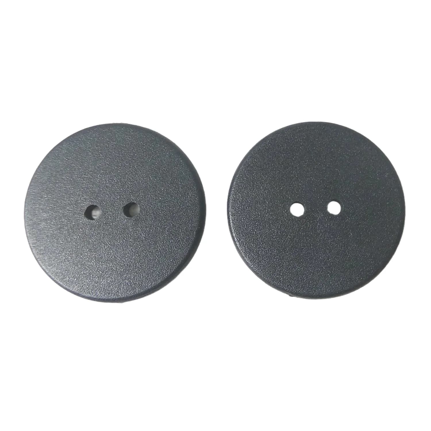Two round black laundry tags with two holes each, on a plain white background.