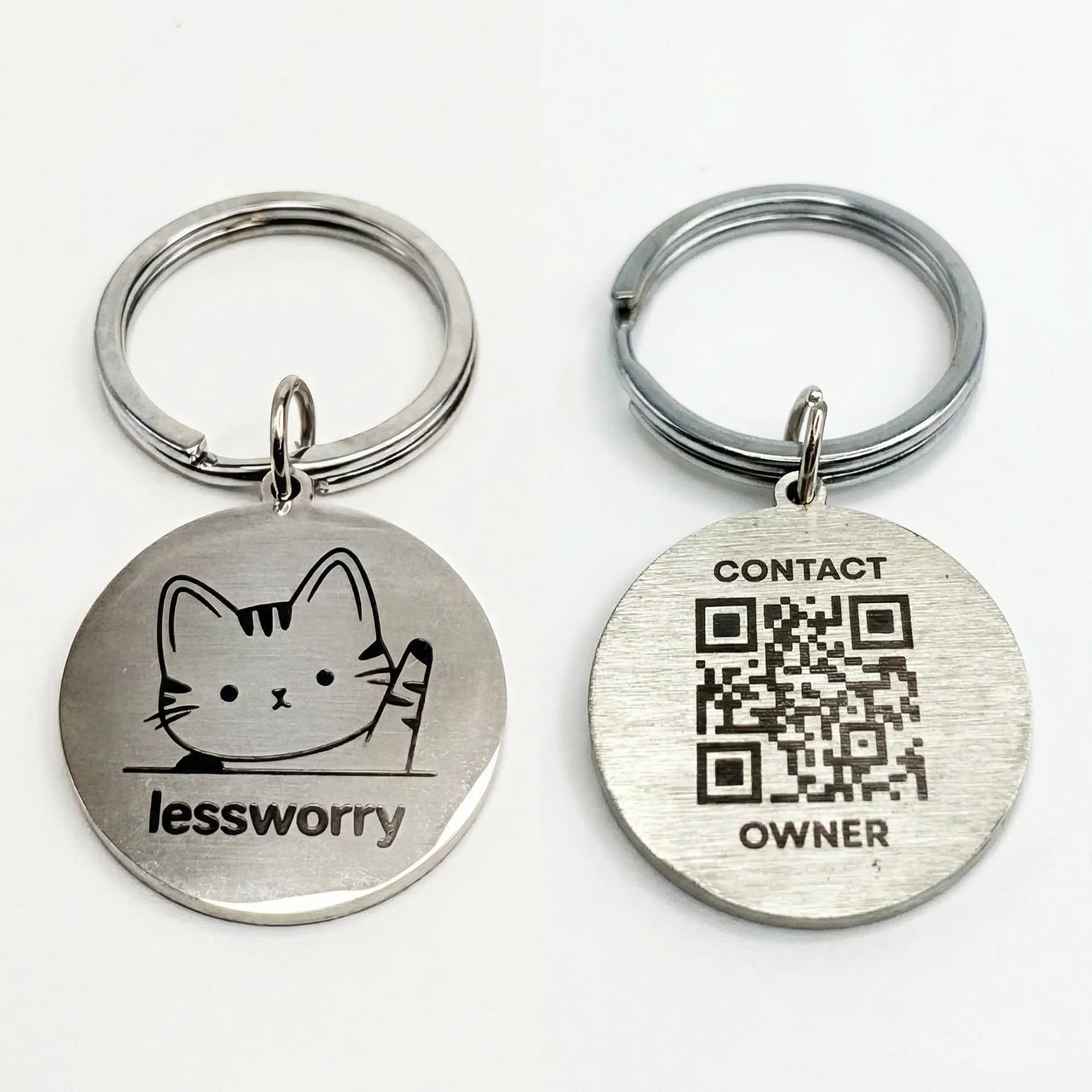 Silver stainless steel pet ID tags with engraved cat illustration on one side and a QR code with contact information on the other side.