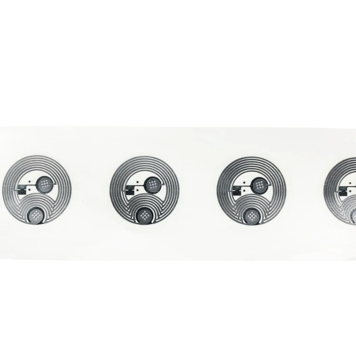 Four transparent circular NFC stickers with visible circuitry on a white background.