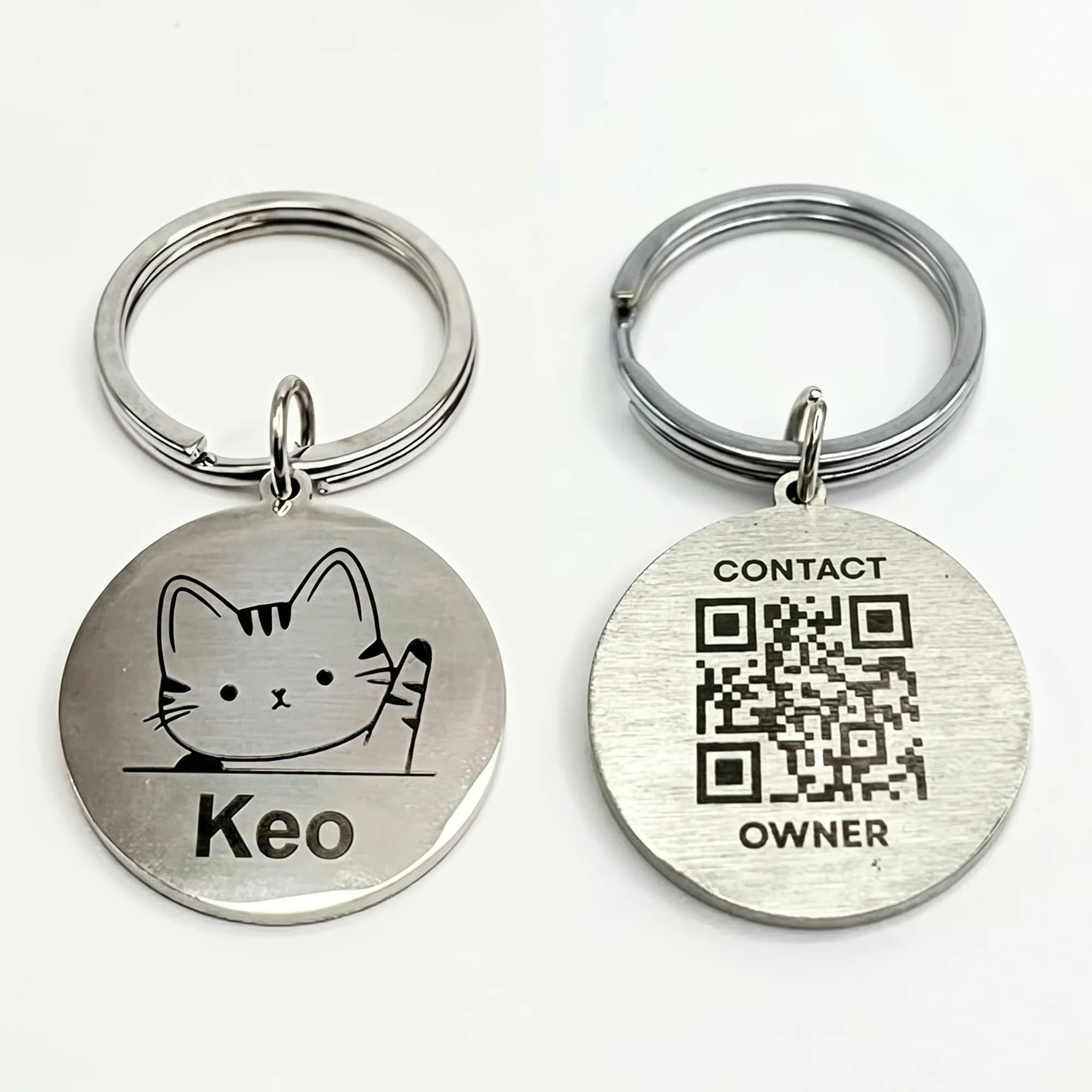 Silver round pet ID tags with engraved designs, QR codes, and contact information on a white background.